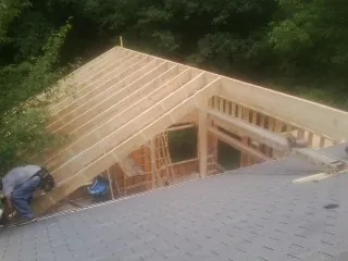 Framing a new roof addition that ties into an existing shingle roof in Miller Place